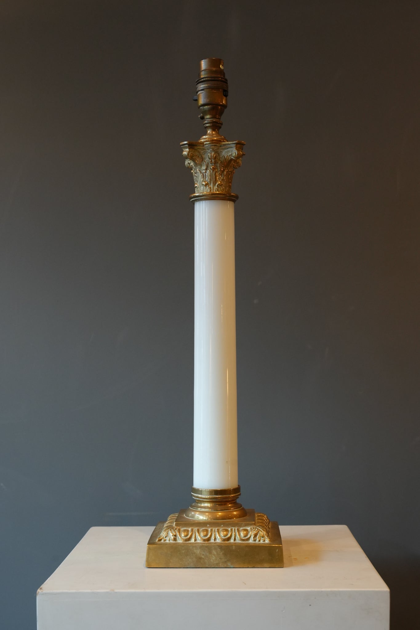 A large brass & opaline glass Corinthian column lamp.