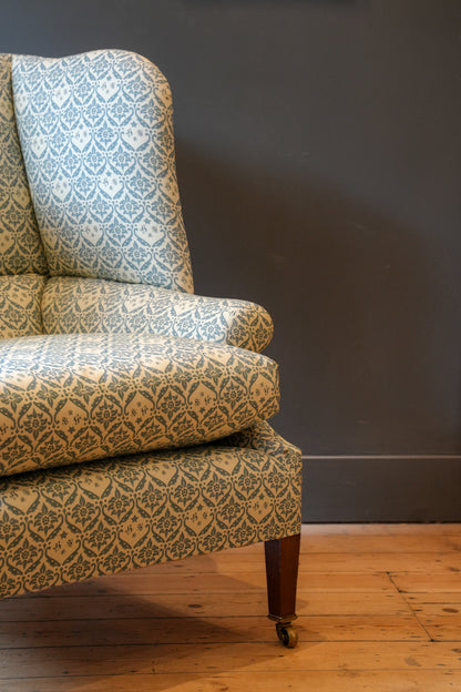 A Howard & Sons Wingback Armchair.