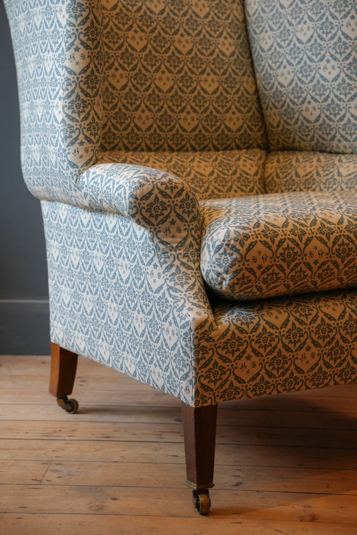 A Howard & Sons Wingback Armchair.