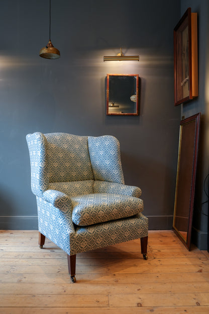 A Howard & Sons Wingback Armchair.