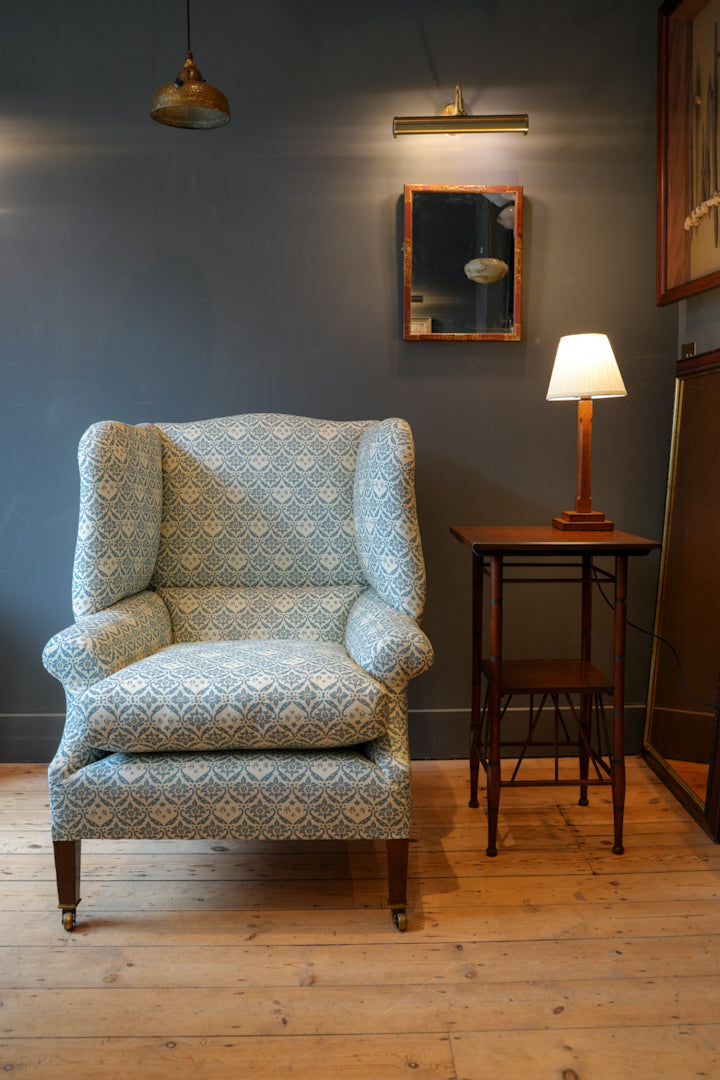 A Howard & Sons Wingback Armchair.